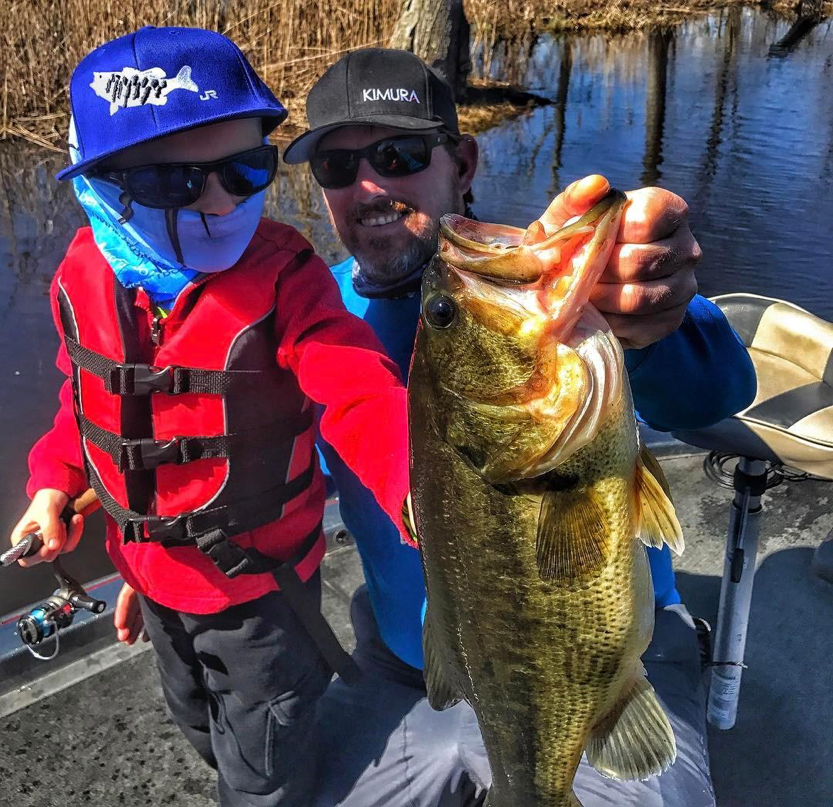 Man and child catching bass